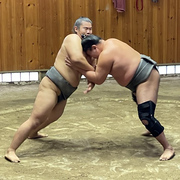 Two sumo wrestlers spa as part of a morning practice session in Tokyo, Japan