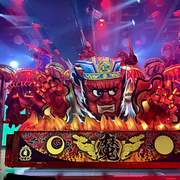 A traditional red Japanese float with taiko drummers on stage at Samurai Restaurant Time in Tokyo