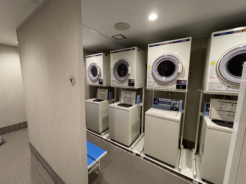 A small laundry room on the Ferry Soleil with four washing machines and tumble driers