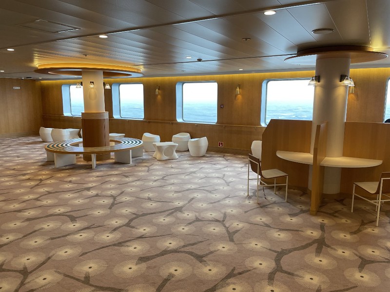 Large lounge area on the fifth floor of the Ferry Soleil with various kinds of seat and large windows looking out at the sea