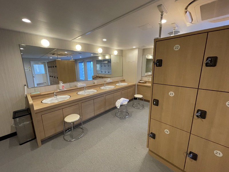 Changing room with sinks and mirrors and personal lockers in the men’s bath on the Ferry Soleil, Japan