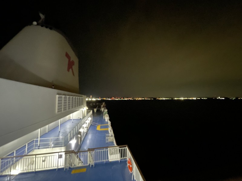 Midnight view over the Ferry Soleil over the dark waters of Tokyo Bay back to the lights of Yokosuka
