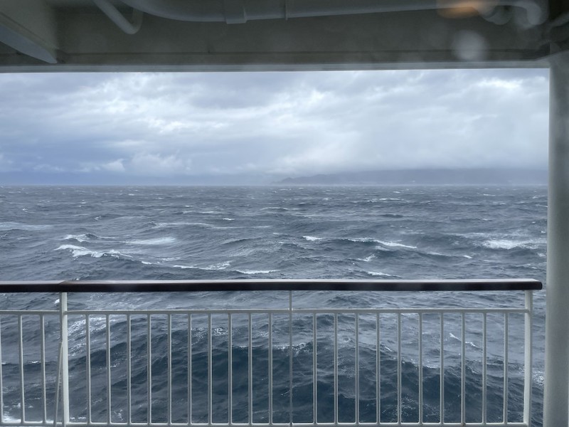 View over the handrail of the Ferry Soleil of the bigger waves around Cape Ashizuri, Japan