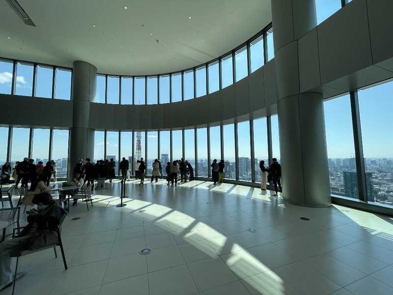 People look at the view from the JP Mori Tower Sky Looby in the Azabudai Hills complex, Tokyo, Japan