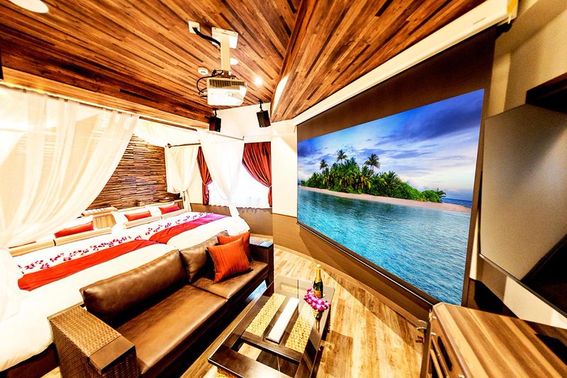 Giant TV, sofa, and wall-length beds in the party room in the BaliAn Resort Forest Ikebukuro love hotel, Tokyo Giant TV, sofa, and wall-length beds in the party room in the BaliAn Resort Forest Ikebukuro love hotel, Tokyo