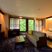 Traditional Japanese elements with sofa and large twin beds in the Hotel Ryumeikan Ochanomizu Honten, Tokyo, Japan