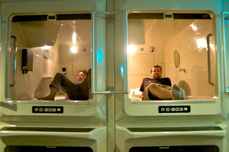 Two men relax in individual capsules in the Capsule Hotel Asahi Plaza copyright Peter Woodman