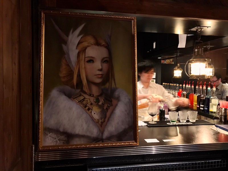 A painting hanging right next to the entrance of the cafe.