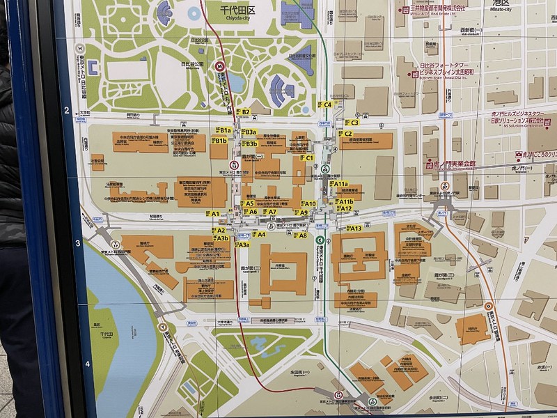 Close up of a typical street map on the platform of a Tokyo train station, showing station exits and the landmarks in the area immediately surrounding the station