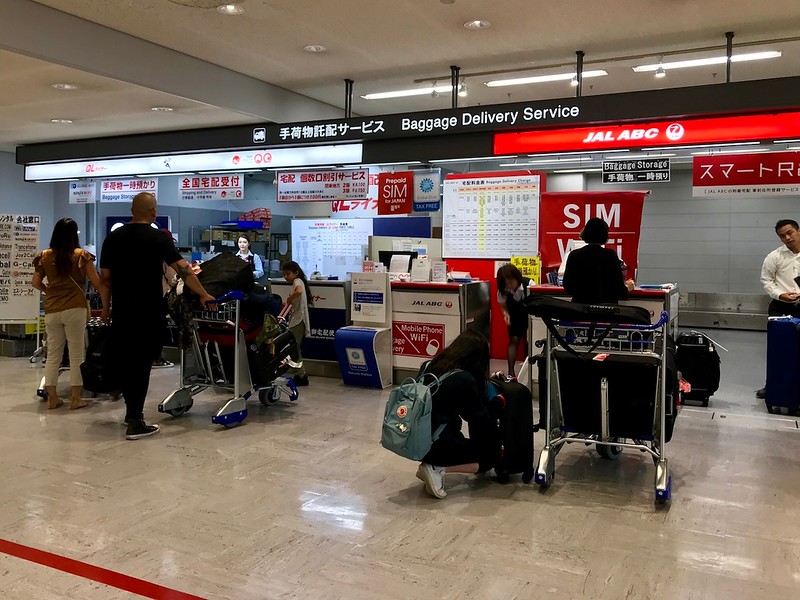 Two of many baggage delivery service counters in Narita Airport.