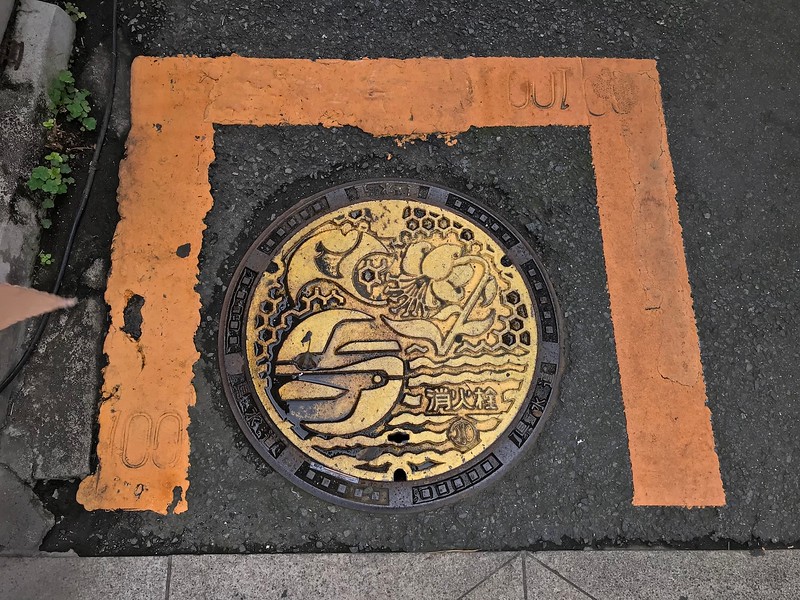 A yellow manhole.
