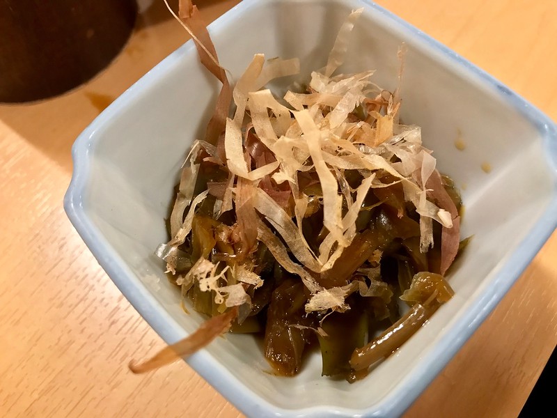 The stems are hidden by a small showering of bonito flakes.