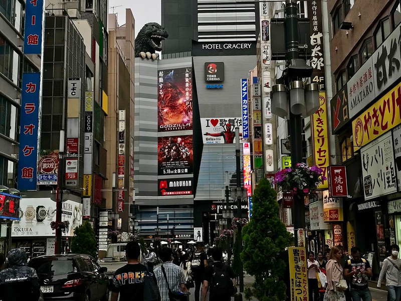 Godzilla peeks over the buildings in the busy Kabukicho entertainment district of Shinjuku, Tokyo, Japan