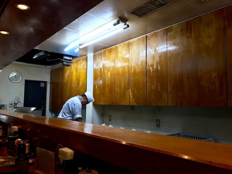 The tonkatsu master working the deep-fryer behind the counter.