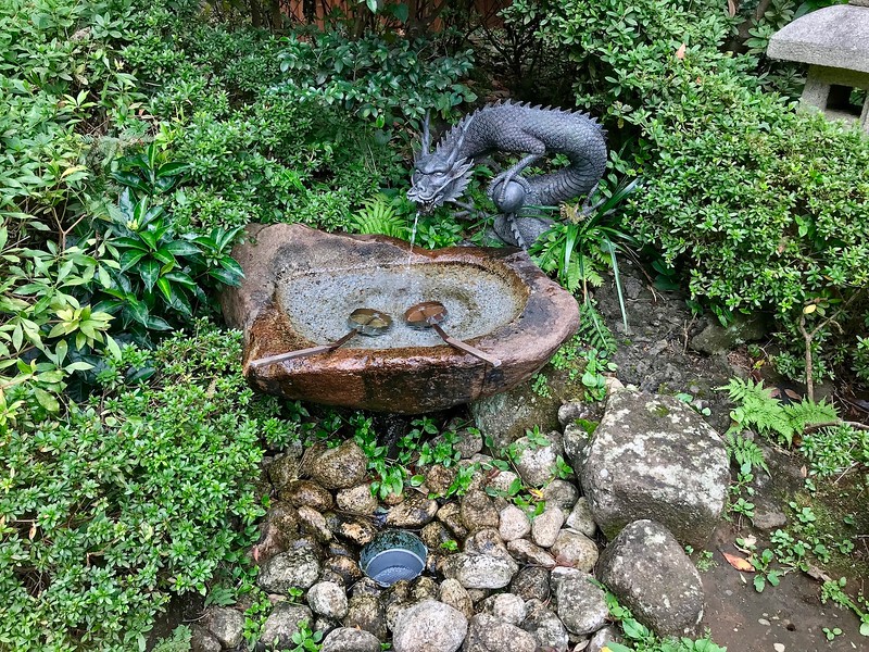 A carved dragon holding a ball.