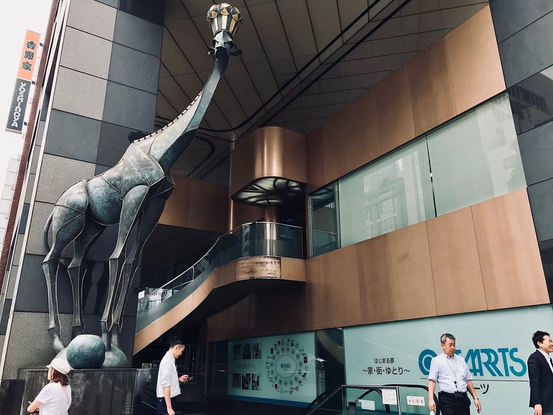 A giraffe statue with a crown at the entrance to the STARTS building. A giraffe statue with a crown at the entrance to the STARTS building.