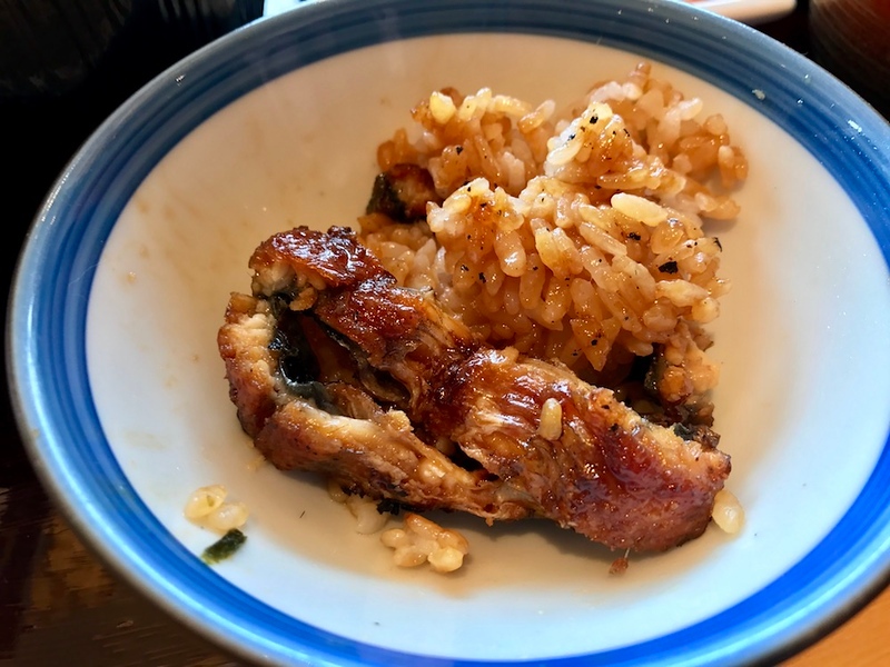 A small portion of grilled eel and rice.
