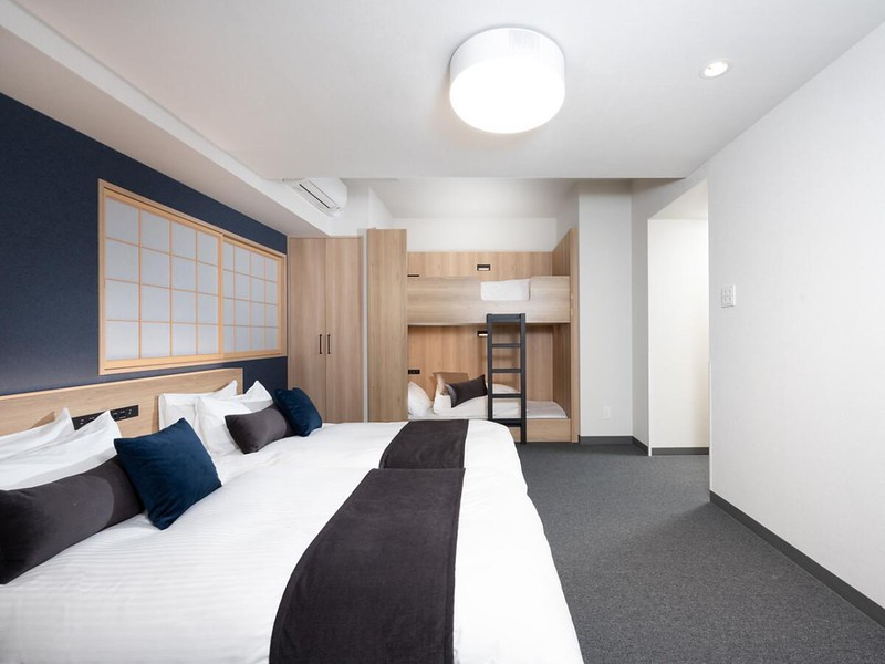 Mimaru Shinjuku West hotel in Tokyo family room with two sets of twin beds and wooden bunk beds