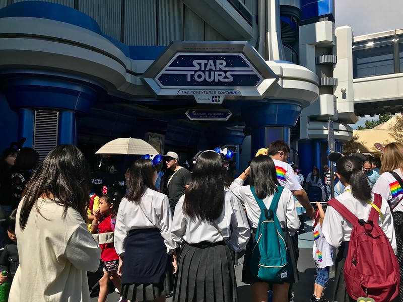 A long queue in front of the Star Tours attraction.