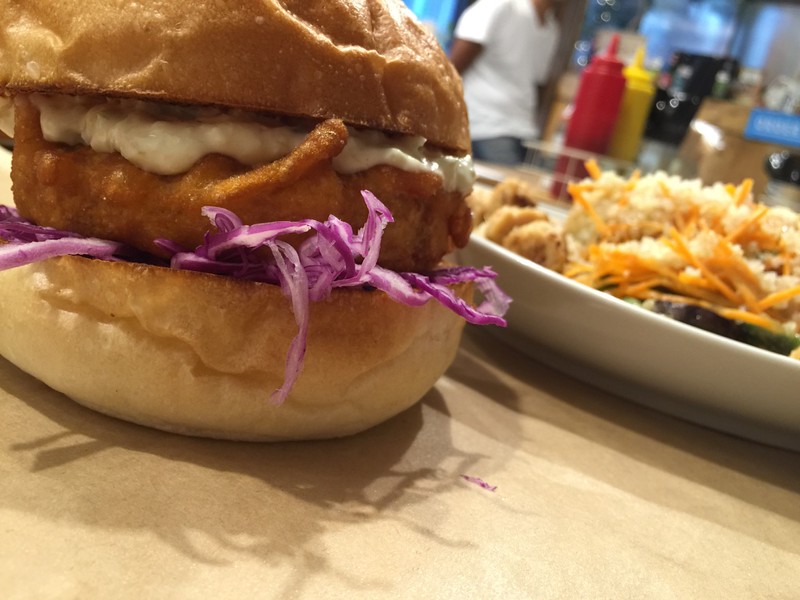 Crispy chicken burger with large salad bowl