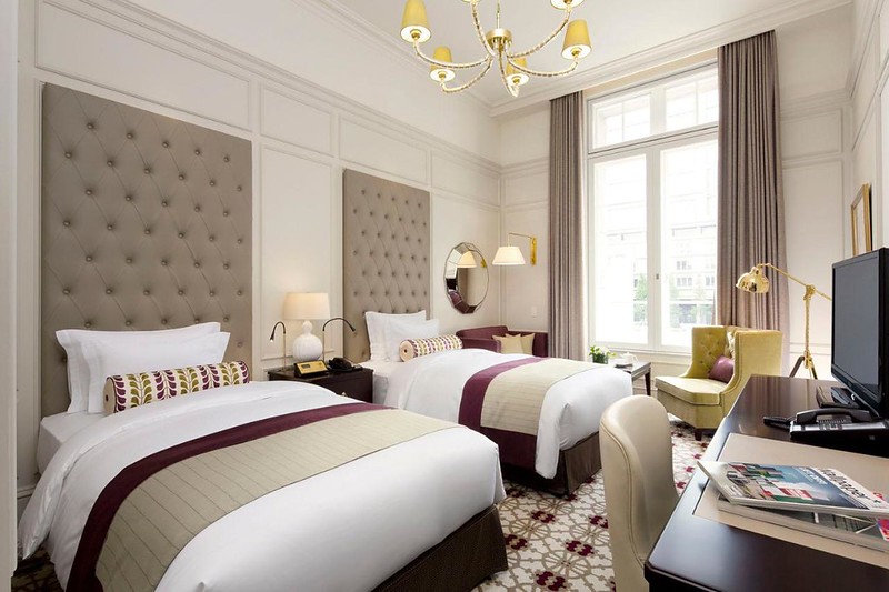 Large and luxurious twin beds in a lavishly decorated guest room in the Tokyo Station Hotel, Japan Large and luxurious twin beds in a lavishly decorated guest room in the Tokyo Station Hotel, Japan