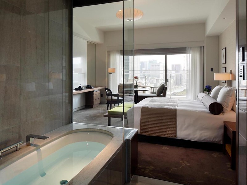 View from the bathroom of a double guest room in the Palace Hotel Tokyo, Japan, with city views outside the window View from the bathroom of a double guest room in the Palace Hotel Tokyo, Japan, with city views outside the window