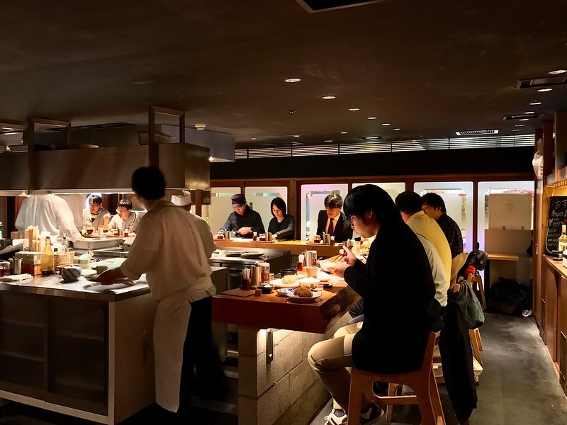Counter seating around an open kitchen, where you can watch tonkatsu cutlets being fried.