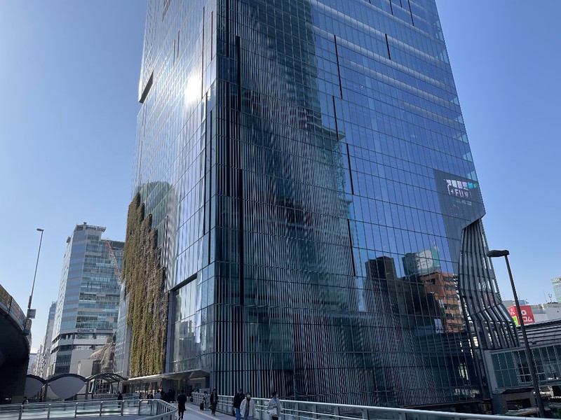The glittering base of Tokyo’s Shibuya Scramble Square building with walkway and main entrance