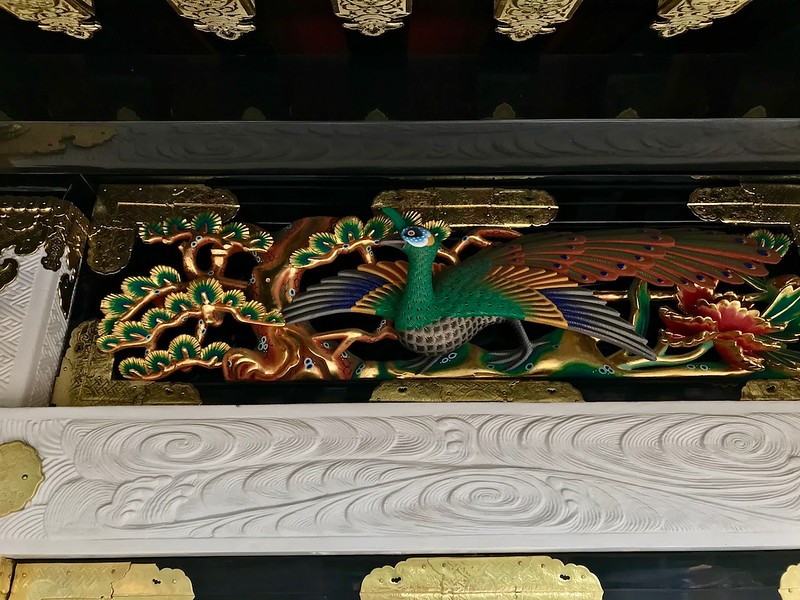 Stunning painted wooden carvings decorating the buildings in the complex.