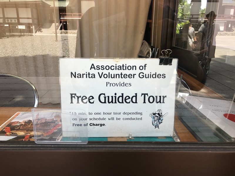 A sign for free walking tours at the temple.