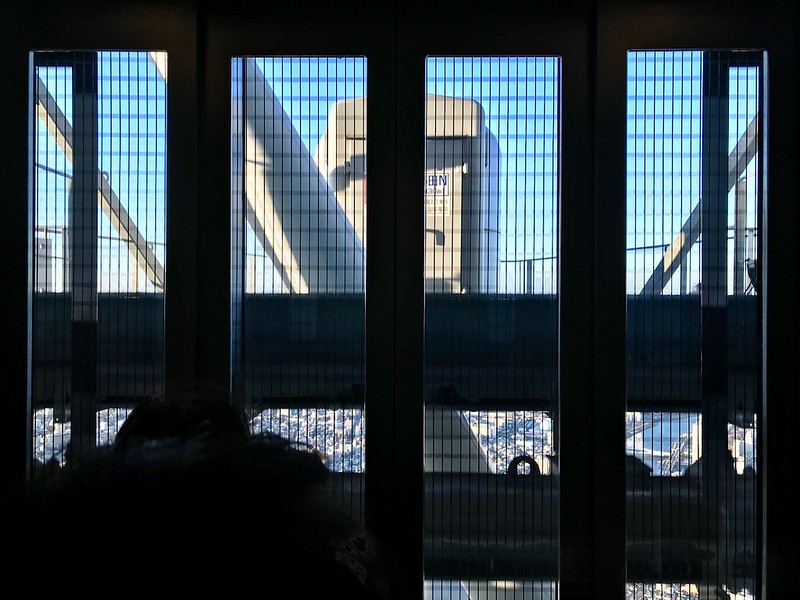 Looking out of the fast-moving elevator.