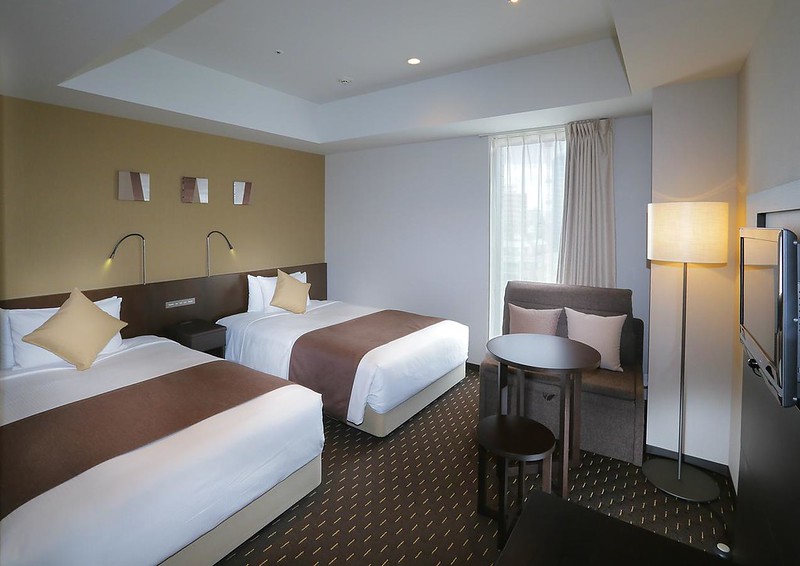 Akihabara Washington Hotel twin room in Tokyo, Japan, with brown and beige interiors and two large beds