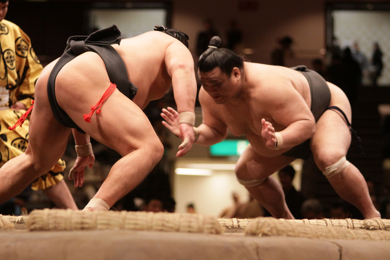 Two sumo wrestlers square up during a match in Tokyo