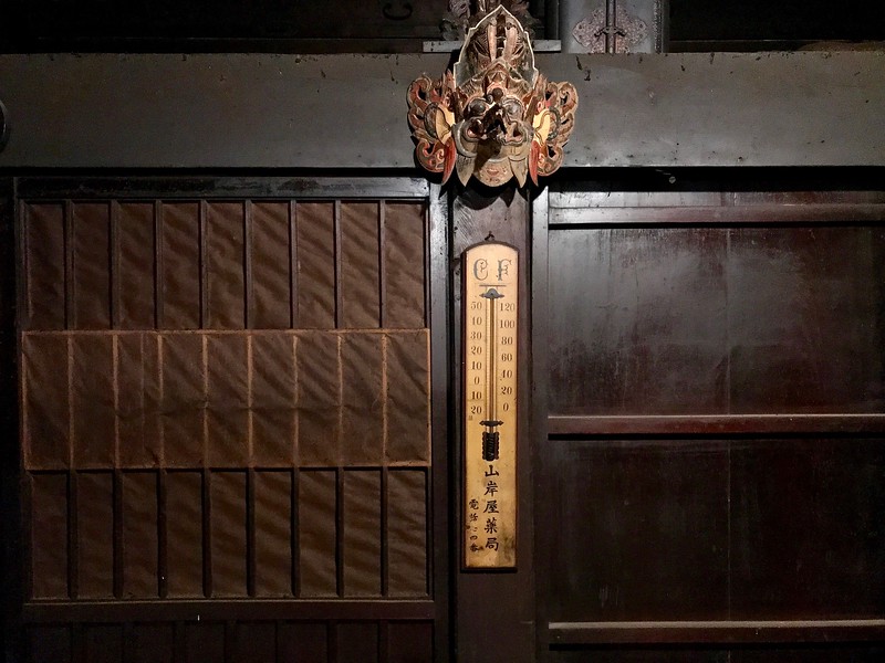 An old-fashioned thermometer on the wall.