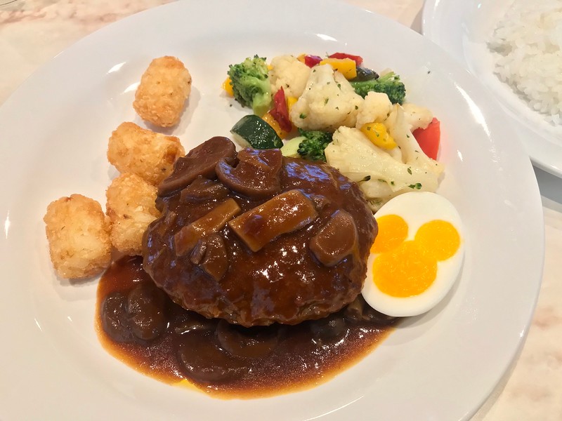 The meat patty with demiglace sauce and a Mickey Mouse half-boiled egg.