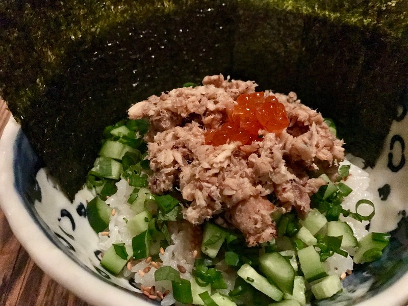 Horo-horo rice bowl topped with vegetables, fish, and salmon roe.