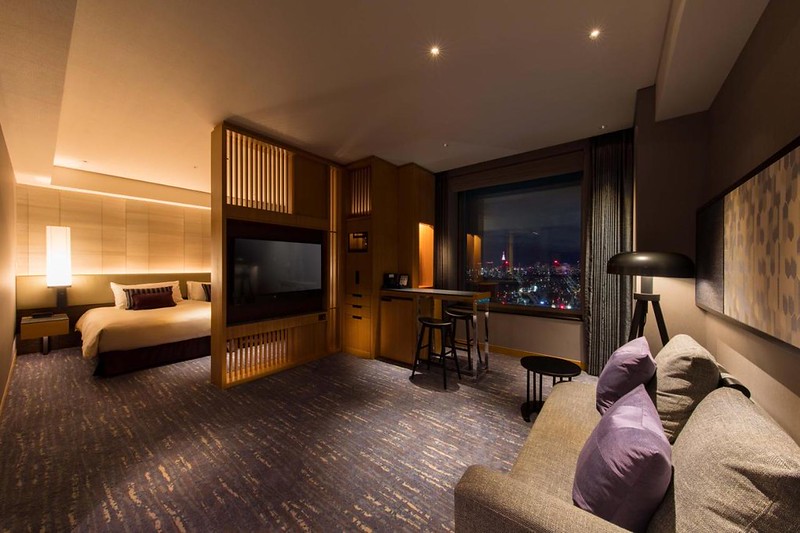 Large suite-like guest room in the Cerulean Tower hotel, Tokyo, Japan, with wide double bed and comfortable living area, separated by a screen Large suite-like guest room in the Cerulean Tower hotel, Tokyo, Japan, with wide double bed and comfortable living area, separated by a screen