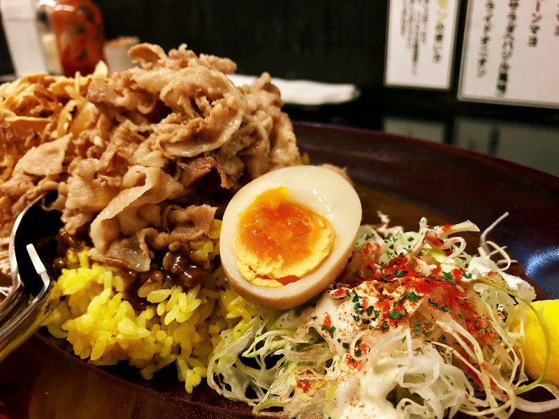 Black curry rice with garlic pork and a marinated egg.