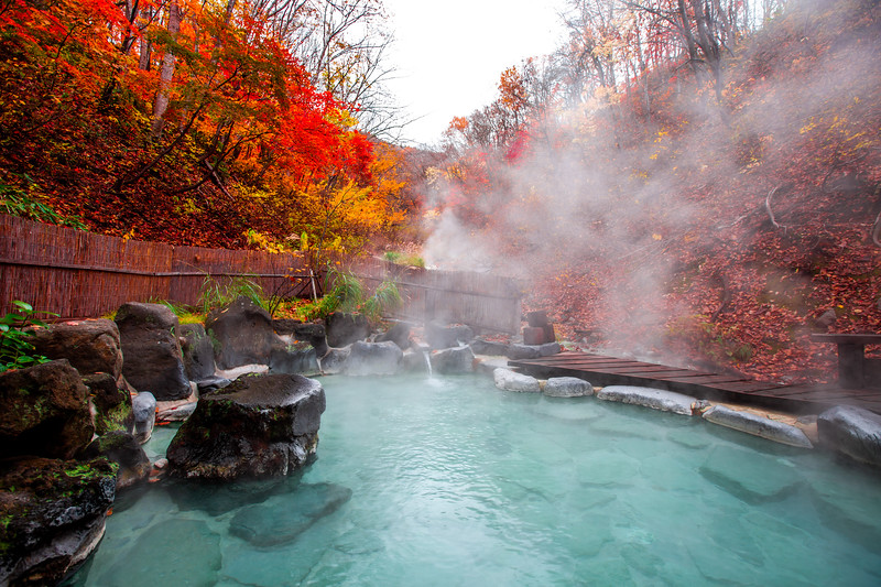 Outdoor bath at Japanese onsen. Editorial credit: Dpongvit / Shutterstock.com
