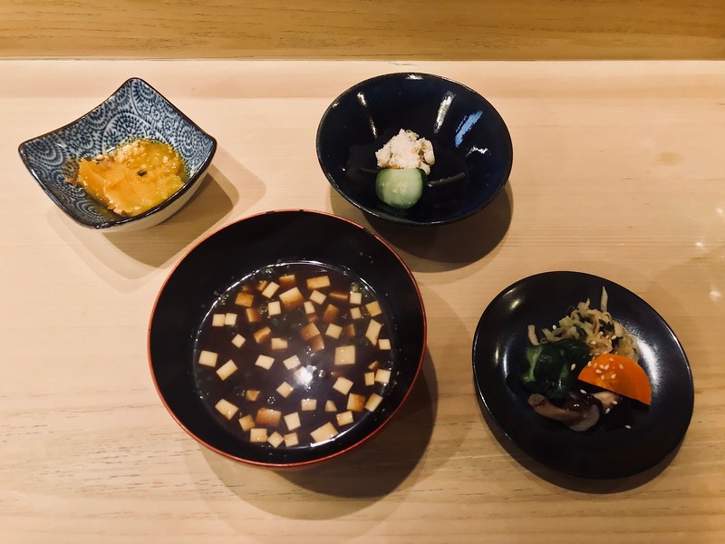 A medley of side dishes, pickles, and red miso soup supplement the rice bowl, giving you all the extra salt you might want.