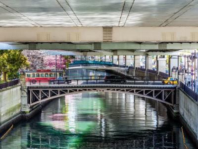 Under the bridge: sakura cherry blossoms and sightseeing bus at Yokohama