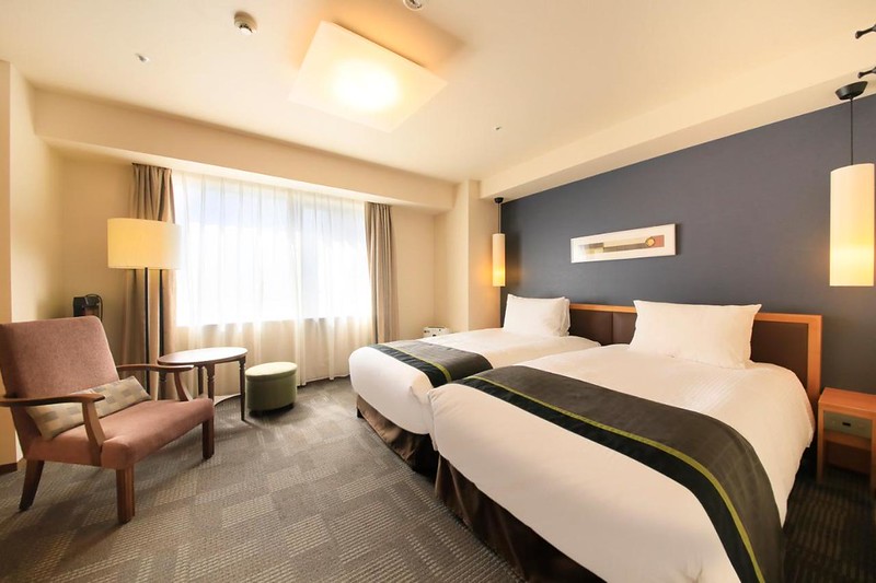 Twin room in the Richmond Hotel Asakusa, Tokyo, Japan, with armchair, standing lamp, and small side table