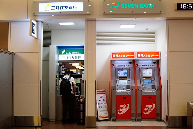Seven Bank ATMs in the departures hall.