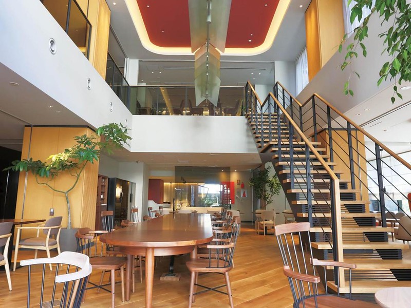 Copper coloured table and staircase to the upper floor in the lobby of the Nohga Hotel in Tokyo, Japan