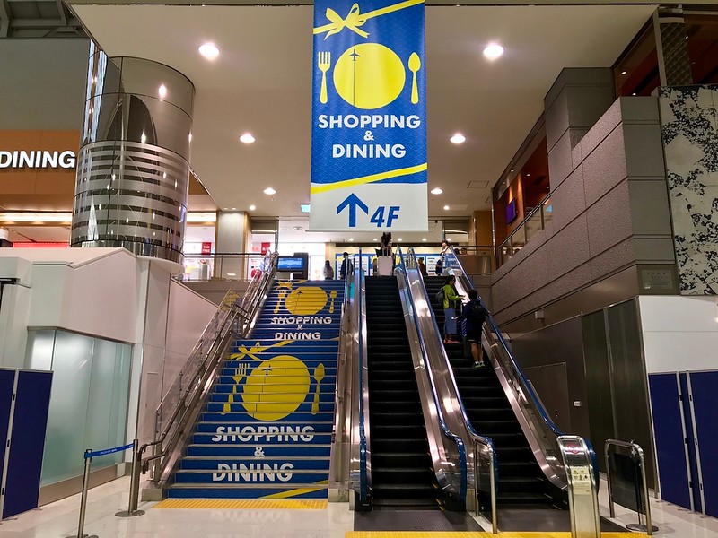 Escalators leading to the shopping and dining area in Terminal 2.