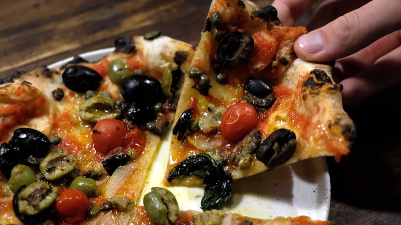 A slice of Olive pizza.