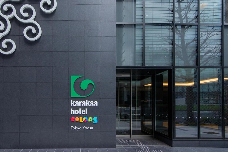 Exterior of the karaksa hotel colors Tokyo Yaesu with grey tiles and glass entrance and hotel logo Exterior of the karaksa hotel colors Tokyo Yaesu with grey tiles and glass entrance and hotel logo