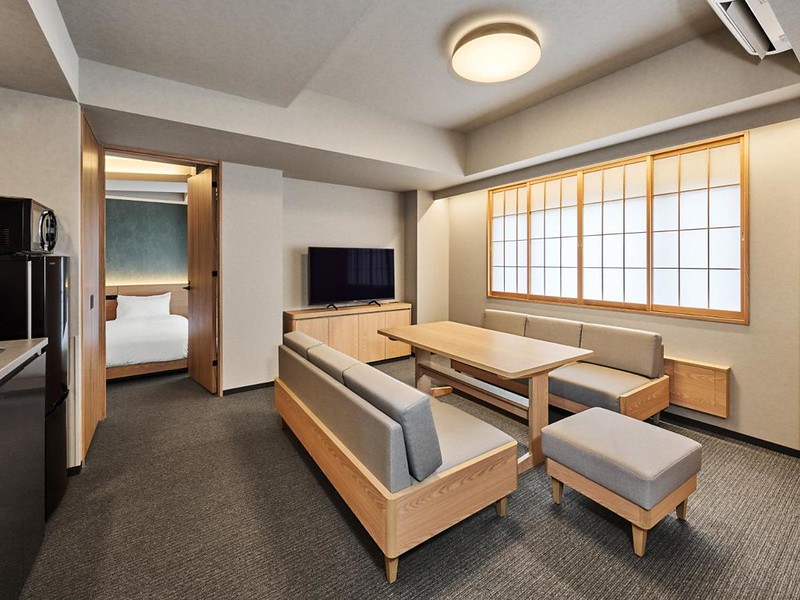 Traditional-style dining area with kitchenette and view of bedroom in the Mimaru Suites Tokyo Nihombashi two-bedroom suite, Japan