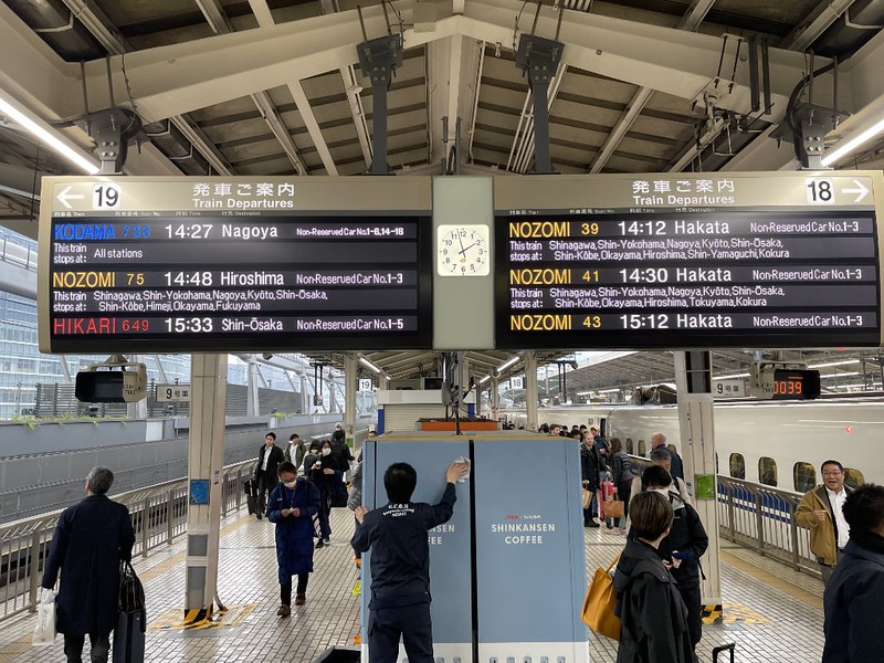 The departures boards on the platform of a Tokyo train station, displaying information about the next three trains due on each platform