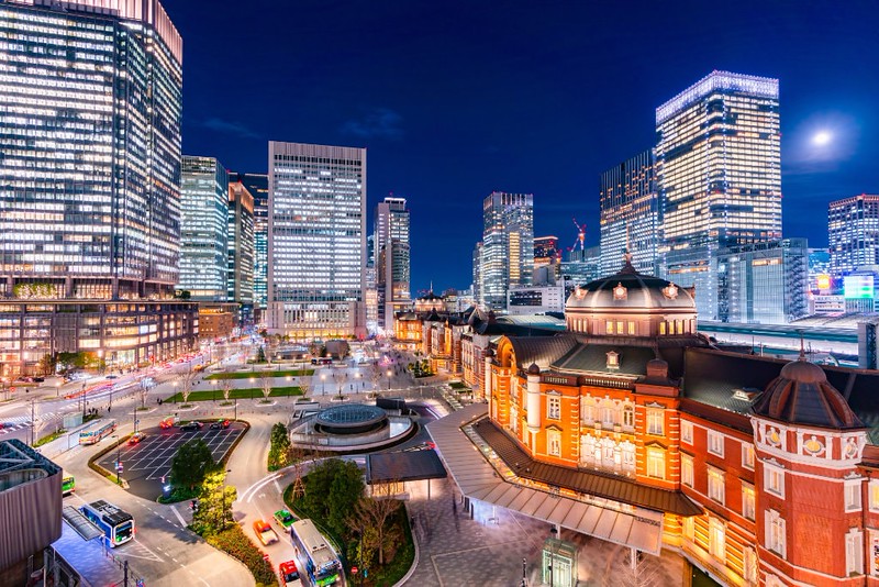Brightly illuminated Tokyo Station and surrounding office buildings viewed from Marunouchi Exit at night